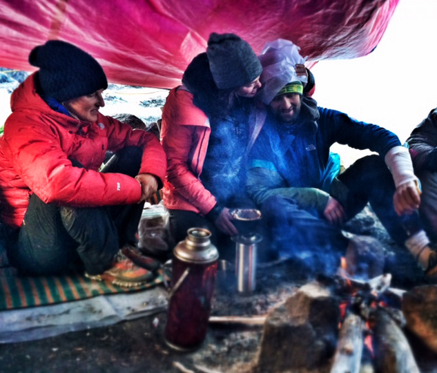 The team rests after attempting the summit of Hkakabo Razi. One of the team members sports a fractured arm. Photo credit: Hilaree O'Neill