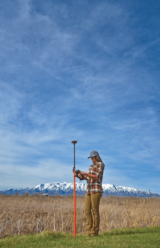 An environmental specialist using the Geode sub-meter GPS receiver with a survey pole for collecting data in the field. 