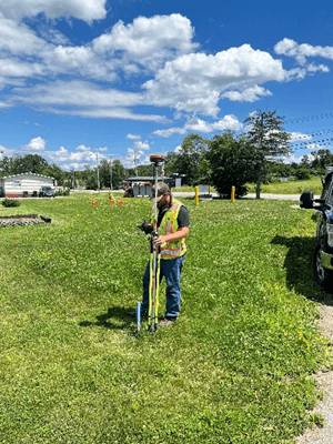 Tyler Button performing underground utility locating while in the field.
